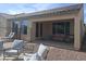 Covered patio with comfortable seating and view of landscaped yard at 10773 W Prickly Pear Trl, Peoria, AZ 85383