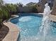 Inviting pool with water feature and lush landscaping at 10773 W Prickly Pear Trl, Peoria, AZ 85383