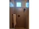 Neutral-toned tile shower with modern fixtures and bright window at 10773 W Prickly Pear Trl, Peoria, AZ 85383