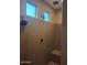 Neutral-toned tile shower features built-in seat and modern fixtures at 10773 W Prickly Pear Trl, Peoria, AZ 85383