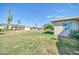 Spacious backyard with desert landscape, a tall cactus, and view of the neighboring homes at 10873 W Clair Dr, Sun City, AZ 85351
