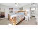 Inviting bedroom features a wooden bed frame, a soft blanket, and lamps on each of the bedside tables at 10873 W Clair Dr, Sun City, AZ 85351