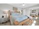 A cozy bedroom showcasing a wooden bed frame with a patterned quilt, complemented by mirrored closet doors at 10873 W Clair Dr, Sun City, AZ 85351