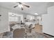 Bright dining area with glass-top table, seating for four, and open view into the kitchen and living room at 10873 W Clair Dr, Sun City, AZ 85351