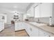 Kitchen features marble countertops, white cabinets, and stainless steel appliances at 10873 W Clair Dr, Sun City, AZ 85351