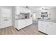 Spacious kitchen features white cabinets, marble countertops, and stainless steel appliances at 10873 W Clair Dr, Sun City, AZ 85351