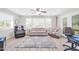 Bright living room with a ceiling fan and lots of natural light at 10873 W Clair Dr, Sun City, AZ 85351