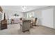 Spacious living room with neutral carpeting, cozy seating, and ample natural light at 10873 W Clair Dr, Sun City, AZ 85351