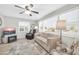 Living room with natural light, ceiling fan, and a TV at 10873 W Clair Dr, Sun City, AZ 85351