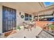 Inviting covered patio with seating area, perfect for outdoor relaxation and enjoying the Arizona weather at 10873 W Clair Dr, Sun City, AZ 85351