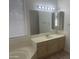 Bathroom featuring tile flooring, single sink vanity, and window with blinds at 11109 W Amelia Ave, Avondale, AZ 85392