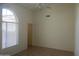 Bright bedroom with tile flooring, a ceiling fan, and a large window at 11109 W Amelia Ave, Avondale, AZ 85392