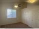 Bedroom with carpet flooring, ceiling fan, and a closet at 11109 W Amelia Ave, Avondale, AZ 85392
