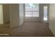 Carpeted bedroom with a window offering natural light and a door to the backyard at 11109 W Amelia Ave, Avondale, AZ 85392