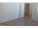 Bedroom featuring tile flooring and a doorway leading to another room at 11109 W Amelia Ave, Avondale, AZ 85392
