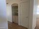Hallway with built-in shelving next to a white interior door at 11109 W Amelia Ave, Avondale, AZ 85392
