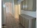 Hallway with tiled floors and a built-in cabinet at 11109 W Amelia Ave, Avondale, AZ 85392