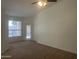 Bright living room featuring neutral tones, carpet flooring, ceiling fan, and natural light at 11109 W Amelia Ave, Avondale, AZ 85392