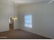 Neutral living room with a window, a ceiling fan, and neutral walls at 11109 W Amelia Ave, Avondale, AZ 85392