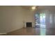 Comfortable living room with tile floors, a fireplace, and a sliding glass door to the backyard at 11109 W Amelia Ave, Avondale, AZ 85392