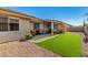 Backyard with artificial turf, an outdoor seating area, and desert landscaping at 11312 E Newcastle Ave, Mesa, AZ 85209