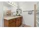 Bathroom features wood vanity with a light countertop, tile floors, and glass block window at 11312 E Newcastle Ave, Mesa, AZ 85209