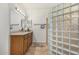 Bathroom features vanity, glass block window, and tiled floors at 11312 E Newcastle Ave, Mesa, AZ 85209