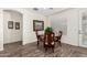 Cozy dining area with wood-look floors, a round table, and natural light at 11312 E Newcastle Ave, Mesa, AZ 85209