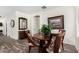 Charming dining area featuring wood-look floors, a round table, and a stylish mirror at 11312 E Newcastle Ave, Mesa, AZ 85209