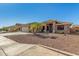 Inviting single-story home with desert landscaping, tile roof, and spacious three-car garage at 11312 E Newcastle Ave, Mesa, AZ 85209