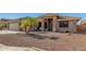 Inviting single-story home with desert landscaping, tile roof, and covered entry way at 11312 E Newcastle Ave, Mesa, AZ 85209