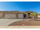 Charming single-story home featuring a well-manicured desert landscape, tile roof, and a spacious two-car garage at 11312 E Newcastle Ave, Mesa, AZ 85209