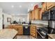 Kitchen featuring wood cabinets, granite counters, stainless steel appliances and a black dishwasher at 11312 E Newcastle Ave, Mesa, AZ 85209