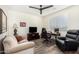 This living room includes a ceiling fan, a television, and a comfortable seating area at 11312 E Newcastle Ave, Mesa, AZ 85209