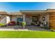 Charming covered patio with comfortable seating, decorative plants, and brick pavers at 11312 E Newcastle Ave, Mesa, AZ 85209