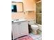 Functional bathroom with white vanity, square mirror, shower and toilet for simple, clean living at 11653 N Hacienda Dr, Sun City, AZ 85351
