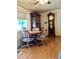 Cozy dining area features a ceiling fan, wood floors, and a classic wooden china cabinet at 11653 N Hacienda Dr, Sun City, AZ 85351