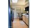 Efficient kitchen area with light wood cabinets, appliances, and adjacent dining seating at 11653 N Hacienda Dr, Sun City, AZ 85351