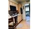 Well-lit kitchen features wood cabinets, black appliances, and direct access to the backyard at 11653 N Hacienda Dr, Sun City, AZ 85351