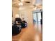 Spacious living room with wood floors, comfortable seating, and an open floor plan at 11653 N Hacienda Dr, Sun City, AZ 85351