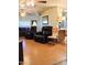 Relaxing living room with comfortable leather recliners, wood flooring, and ceiling fans at 11653 N Hacienda Dr, Sun City, AZ 85351