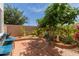 Landscaped backyard with potted plants and brick flooring at 1232 S 120Th Ln, Avondale, AZ 85323