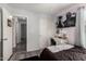 A bedroom featuring gray floors, a bed, a desk, and a closet with sliding doors at 1232 S 120Th Ln, Avondale, AZ 85323