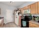 Practical kitchen featuring a refrigerator, microwave, and stove with plenty of storage space at 1232 S 120Th Ln, Avondale, AZ 85323