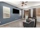 Comfortable living room featuring a ceiling fan, natural light, and wood-style flooring, perfect for relaxation at 1232 S 120Th Ln, Avondale, AZ 85323