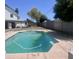 Backyard view with a sparkling in-ground pool surrounded by ample space for outdoor living and entertaining at 13438 N 18Th Ln, Phoenix, AZ 85029