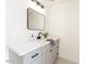 Bathroom featuring modern mirror, white countertop and gray cabinets at 13438 N 18Th Ln, Phoenix, AZ 85029