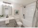 Bright bathroom features a shower over tub, new vanity with grey cabinets and modern fixtures at 13438 N 18Th Ln, Phoenix, AZ 85029