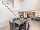 Comfortable dining room with modern gray chairs, table, and staircase views to the upper level at 13438 N 18Th Ln, Phoenix, AZ 85029