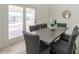 Dining area overlooking the pool featuring a gray table, chairs and access to the patio at 13438 N 18Th Ln, Phoenix, AZ 85029
